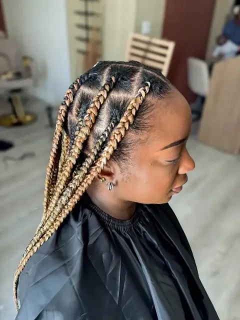 Blonde feed-in braids with clean parting and long protective length